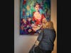 A guest admires the painting of Manto Mavrogenous, one of the heroines of the Greek Revolution, at the opening reception for #WeAreGreekWarriors at Hellenic Museum of Michigan.