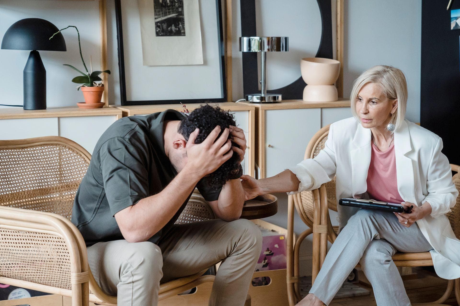 A man in a therapy conversation in a calm room