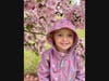 Charlotte posing with a crabapple tree.