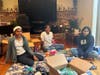 Sakthi Satrawada, Shradha Rachamreddy, and Riya Rajakumar building feminine hygiene and dental kits.