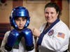 A photo taken when she was a Green Belt, celebrating her achievements at the Regional Championship!