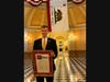 John P. Beall, founder of Old California Botanicals, standing in the lower rotunda of the California Statehouse holding the California State Senate resolution presented on the Senate Floor on May 14 by Sen. Ochoa-Bogh.