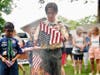 With focus and respect, a Scout from Troop 170 carries out the solemn duty of a flag retirement ceremony, a tradition honoring the significance of the American flag