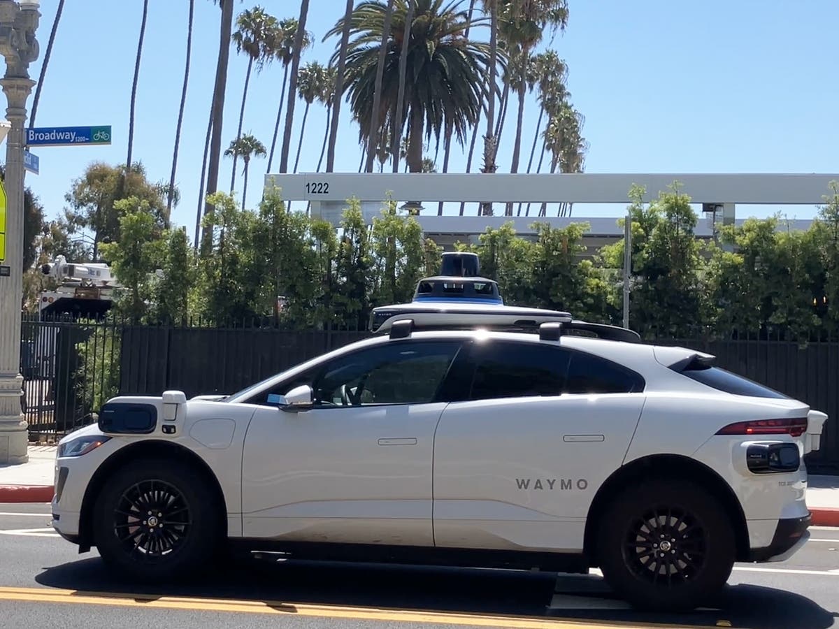 A Waymo autonomous vehicle passes the company’s charging facility at 1222 Broadway in Santa Monica.