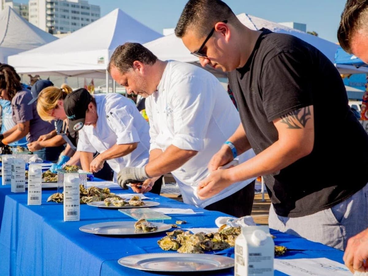 Chefs prepare oysters during a previous Off The Hook Seafood Festival at the Santa Monica Pier. The festival returns Sunday for its eighth year.