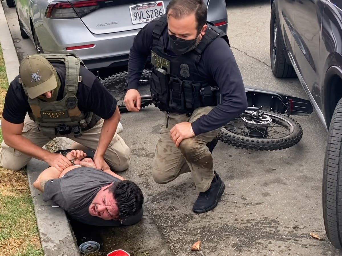 Federal immigration agents restrain Ricardo Gonzalez on a North Long Beach street Saturday, Oct. 17, 2026. Gonzalez, a U.S. citizen, alleges agents used excessive force during the encounter, leaving him with a broken arm.