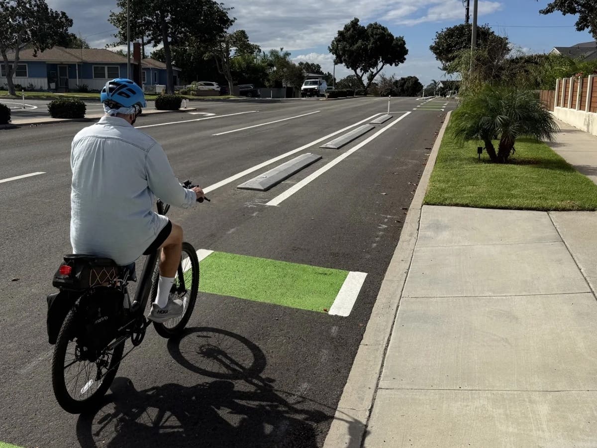 A cyclist rides along the newly completed concrete-curb-protected bike lanes on Palos Verdes Boulevard in Redondo Beach. The improvements separate bicycle traffic from passing vehicles along approximately 0.4 miles of roadway.