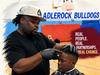 Master Daniel Wilkerson III providing a haircut at Cradlerock Elementary School's 2026 Back to School Event