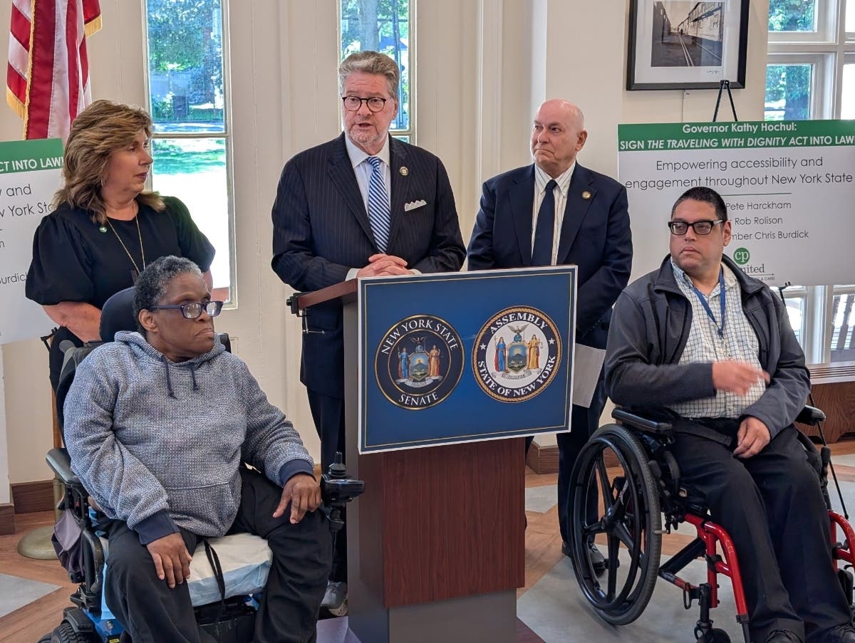 Sen. Pete Harckham at the podium with Asm. Chris Burdick and (l-r) Penny-Lynn Pagliaro from CP Unlimited, Betty Williams and Diego Ortiz