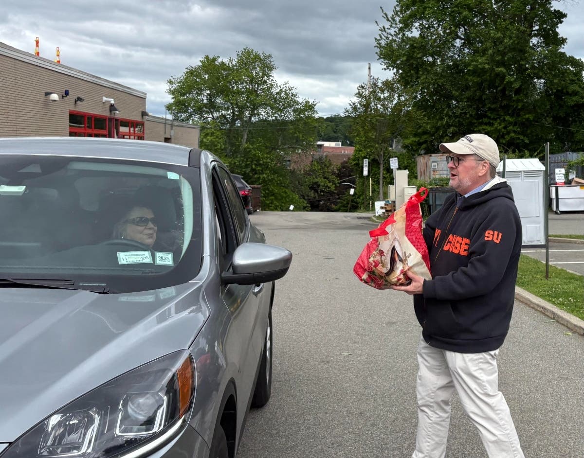 State Sen. Pete Harckham in Peekskill accepting a bag of donated groceries at a food drive, the 21st he has hosted, in May 2026