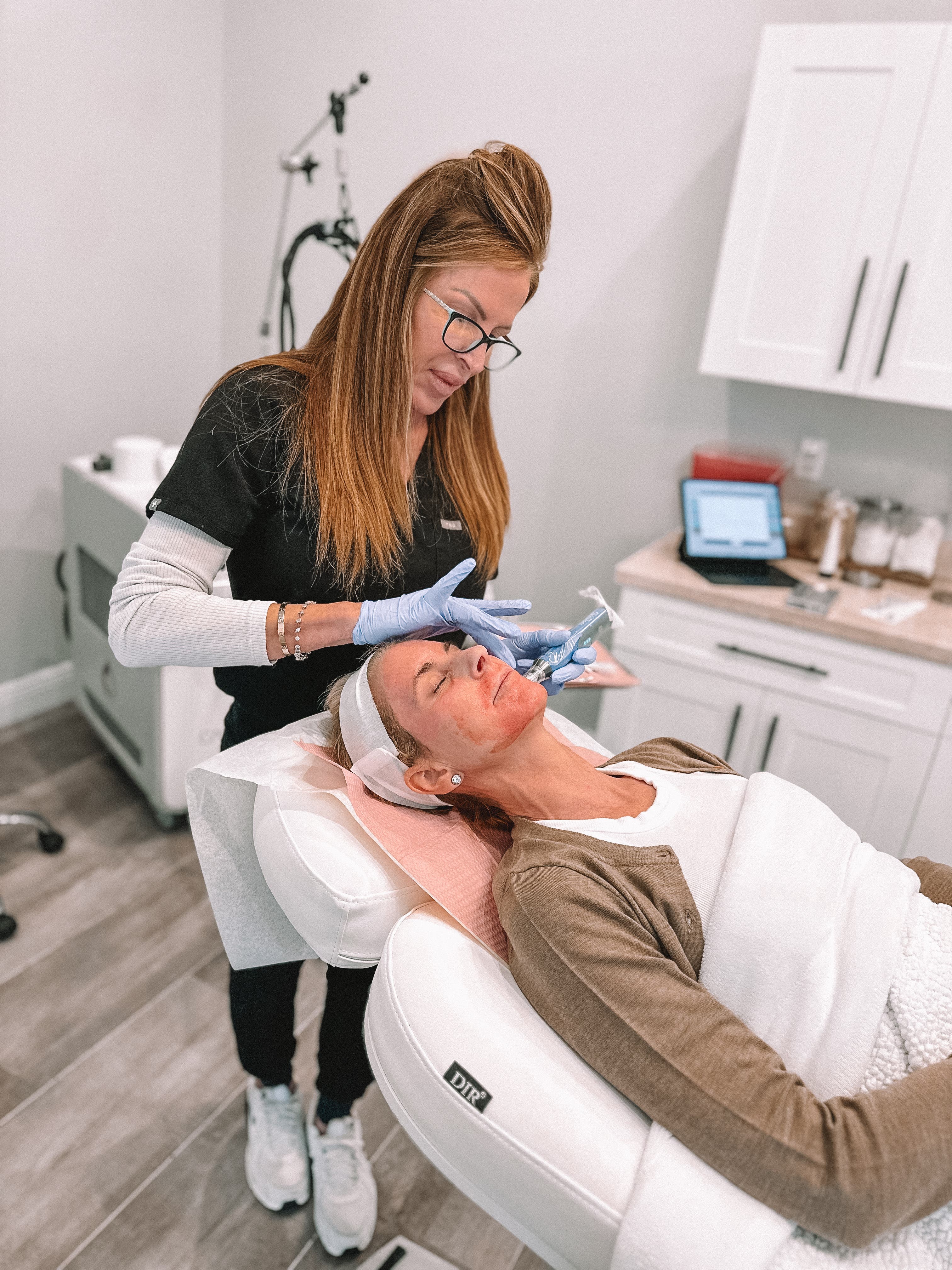 Patient receiving facial microneedling treatment from a provider at Refresh - Aesthetics & Wellness in Florida