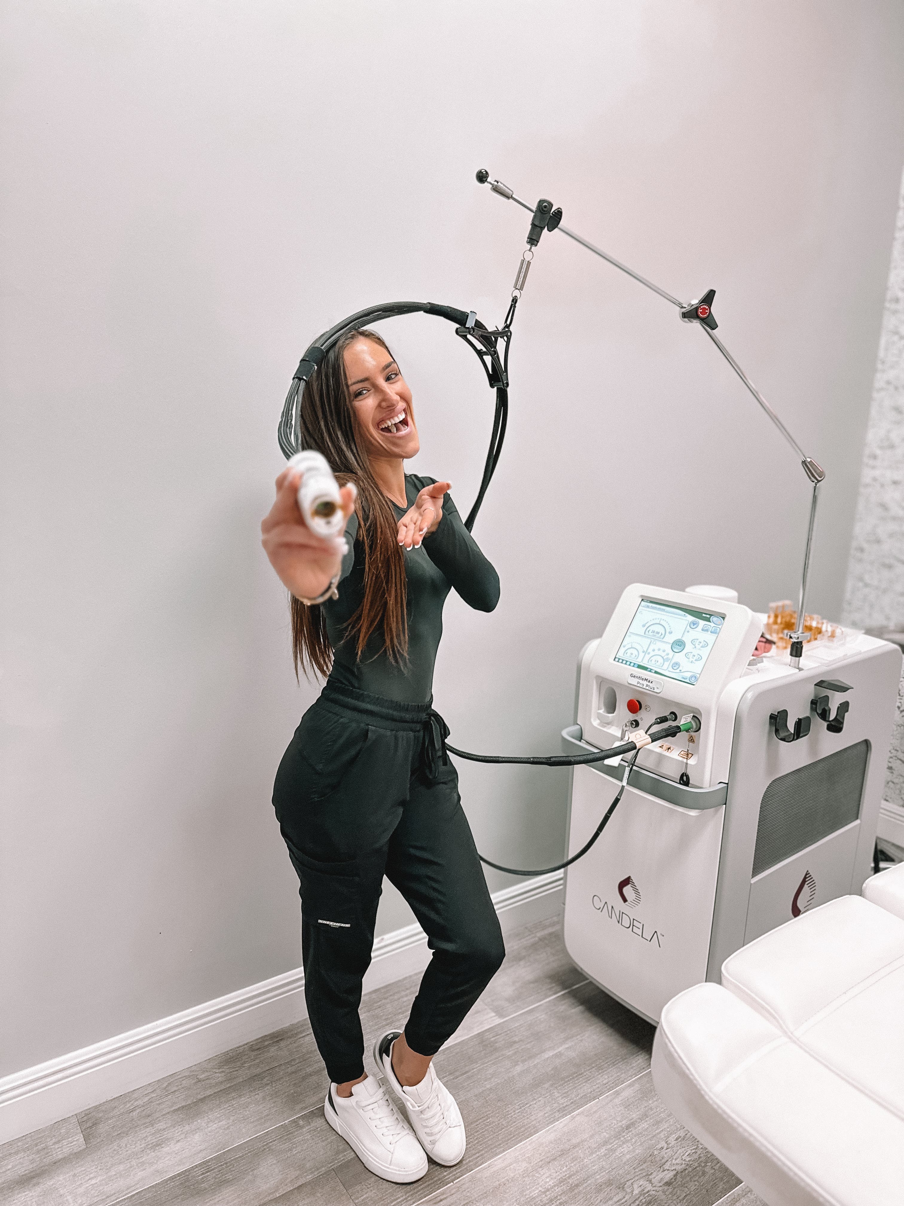 Refresh - Aesthetics & Wellness provider standing beside a Candela laser hair removal system in Florida