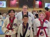 (left to right) Kataliena holding her Gold and Silver medals, Matteo wearing his championship medal, and Kora showing off her medal, with their instructor Master Virginia Folger standing proudly behind them! So proud of Team Middlebury Martial Arts.