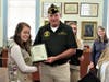 Grace Collins receives from Brookfield VFW Post Commander Joseph C. Beal Certificate naming her Scout of the Year.