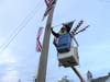 Brian Locke places flags on Brookfield telephone poles.