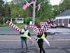 John Kennedy carries flags to be mounted along Route 25.