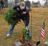 Brian D'Ambrosia of the Brookfield VFW Ct Riders Goup walks the burial grounds placing wreaths