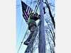 VFW Member Andy Ipkovich mounts flag on telephone pole along Rt. 25 