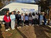 Edison High School student volunteers pose for a group picture following a distribution.