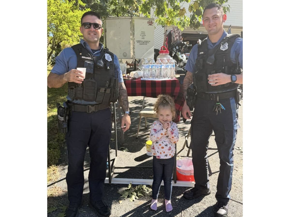 Hopatcong police officers pose with young lemonade stand entrepreneur Iver.