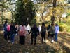 Women gather hand-in-hand during the opening welcome circle at a Revive2Thrive Revive Day, creating a space for connection, support and shared understanding among breast cancer survivors.