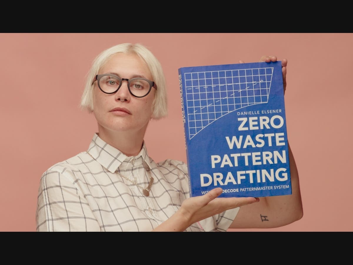 Founder, Danielle Elsener holding the prototype of the Zero Waste Pattern Drafting book