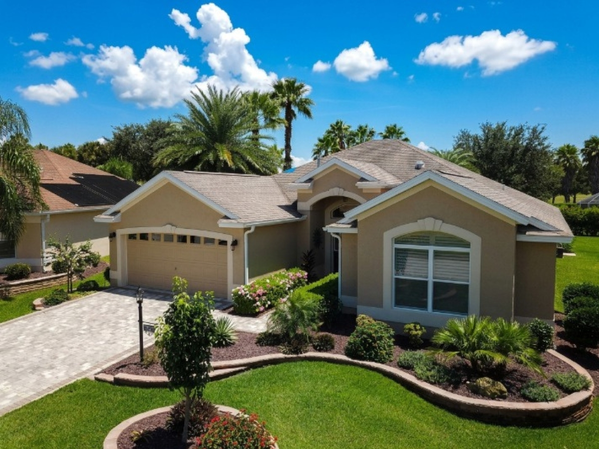 Completed roof replacement on a tan stucco home in The Villages, FL. Photo: Batterbee Roofing