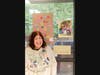 Denise smiles as she shows off the artwork at Opportunity Partners' art show.