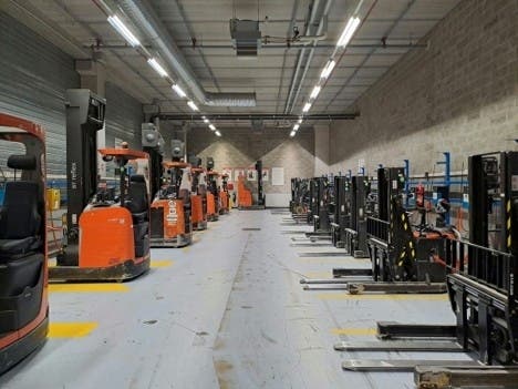 Pallet jacks lined up in a warehouse