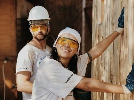 A couple managing a home improvement project funded by a personal loan from a credit union.
