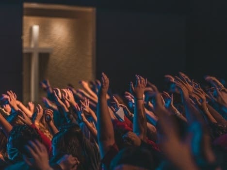 People raising their hands during a worship service