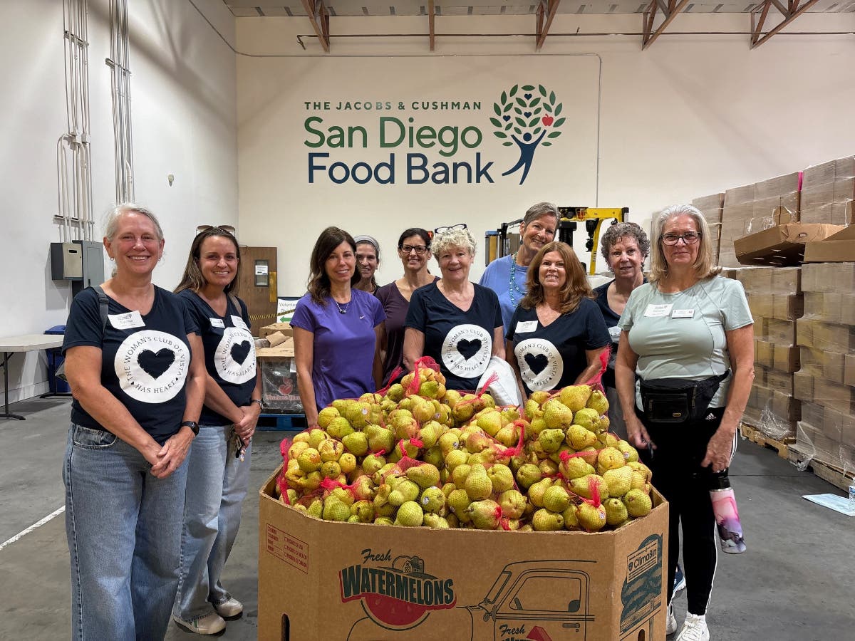 Woman's Club of Vista volunteers pose by some of the sorted and packed pears. Left to right: Cynthia Ritter, Lindsey Shilts, Stephanie George, Sara Veth, Wendy Woodhall, Cindy Tosczak, Dianne Ellison, Liz Franciscus, Judy Stevens, Debbie Williams.