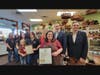 Surrounded by friends and family, Susan Hordych, owner of Suzi's Sweet Shoppe, accepts a proclamation from Middletown Mayor Tony Perry and a joint resolution from State Assemblyman Gerard Scharfenberger as Middletown Committeewoman Kimberly Kratz looks on