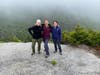 Emily Rusk, Christina Simpson, and Deaton participate in a training hike on Jennings Peak as they prepare for the 27th annual Wilderness Heals pledge hike in the NH White Mountains to benefit the Stone House.