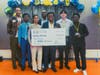 Fortune Avenue youth members (left to right) Elamin Elamin, Rebecca John, Daniel Idenudia, David Huang, and Daniel David pose with Team Advisor, Jake Small (left) and Mental Health Track Judge, Seth Libert (background, center).