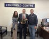 Diana DeLeo (left) and Phil Crawford (right) from A Healthy Lynnfield present the A Healthy Lynnfield Legacy Award to Representative Brad Jones.