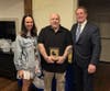 Diana DeLeo (left) and Phil Crawford (right) from A Healthy Lynnfield present the Community Volunteer Award to Michael DiCorato.