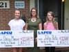 LAFCU's Alyssa Sliger presents scholarships to Daisy Manzer, left, DeWitt, and Julia Pate, right, Lapeer.