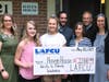 LAFCU’s Alyssa Sliger and Contest winners Julia Pate and Daisy Manzer present a donation to Haven House representatives.
