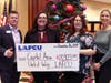 From left, Capital Area United Way’s David Tyler accepts a ceremonial check for $8,923 from LAFCU Giving Committee members Amanda Seger, Teri and Suzi. Funds were raised internally at LAFCU through dress down days and other events in 2019.