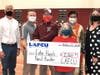 Pictured are, from left, Tim Daman, Lansing Regional Chamber of Commerce; Adam Gumbrecht, band director; Bill DeFrance, superintendent; Jen Eck, Band Boosters president; and Kelli Ellsworth Etchison and Alyssa Troub, LAFCU.