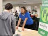 Robyn Howell, LAFCU chief human resources officer, listens to a student during the LAFCU Financial Reality Fair at Lansing Christian School.