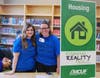Kellie Swiger, LAFCU creative director, and Morgan Pray, assistant manager of LAFCU’s West Lansing Branch, smile between helping Lansing Christian students choose their housing based on their annual salaries and credit scores. 