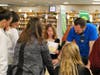 At one of the 13 booths at the Financial Reality Fair, Zac Williams, LAFCU marketing data analyst, counsels a group of Lansing Christian students on how to make good budgetary decisions based on their pre-selected careers and estimated annual salaries. 