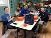Maner Costerisan team members pack laundry detergent at Haven House as part of the firm’s annual Day of Impact.