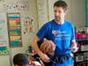 As Maner Cares Day of Impact comes to a close, a child from Elmwood Elementary School in Lansing hugs a Maner Costerisan team member.