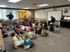 Quality Dairy’s Phil Platte reads to a first-grade class at Winans Elementary during LAFCU’s Listen & Learn–All About Donuts event, which combined storytelling with hands-on financial literacy lessons.