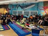 Perry Upper Elementary students explore STEM projects in a dynamic classroom featuring a vibrant undersea mural, made possible by the LAFCU LIFE grant. Cozy seating, like bean bags and cushioned chairs, adds to the engaging learning atmosphere.