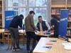 Sean Cervantes, LAFCU’s business development and growth officer, guides Lansing Christian students through the final station of the Financial Reality Fair, helping them assess their financial choices and plan for a secure future.