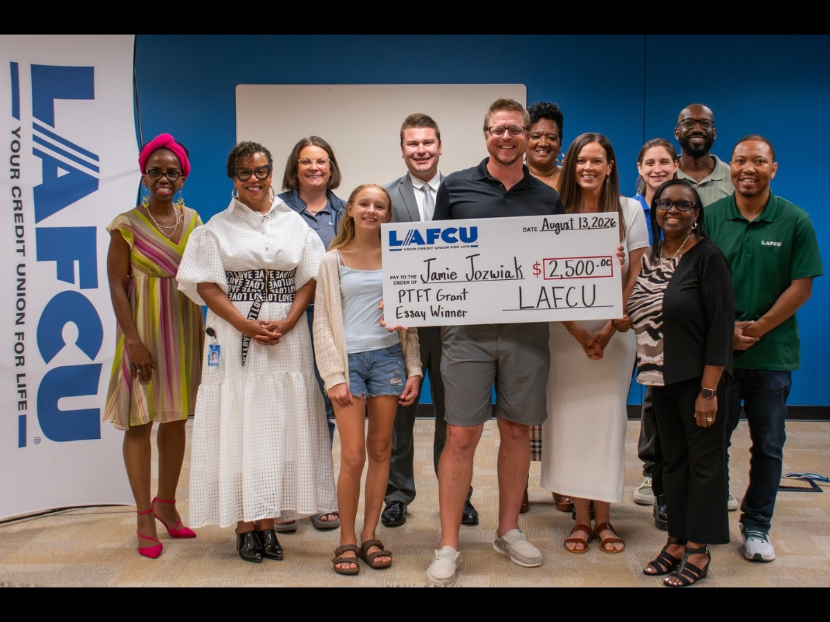 LAFCU team members pose with 2026 Pathway to Financial Transformation Essay Contest winner Jamie Jozwiak and his family.